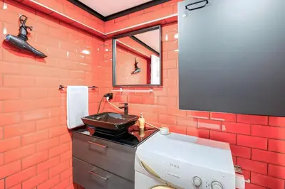 a bathroom with a red brick wall and a sink at HANDMADE in Istanbul