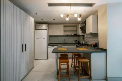 a kitchen with a table and chairs and a refrigerator at Luxon Sapanca Family Villas in Sakarya