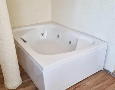 a white bath tub in a corner of a room at La Pearl Konaklama in Istanbul