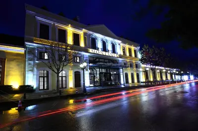 a lit up building on a city street at night at Montania Special Class Hotel in Mudanya