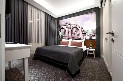 a bedroom with a bed with a painting on the wall at Montania Special Class Hotel in Mudanya