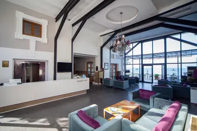 a living room with couches and a fireplace at Montania Special Class Hotel in Mudanya