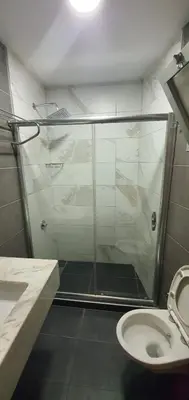 a bathroom with a shower and a sink and a toilet at taksim k suites in Istanbul