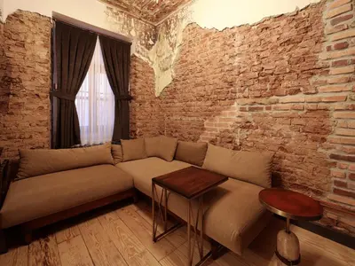 a living room with a couch and a brick wall at Impera Hotel - Special Category in Istanbul