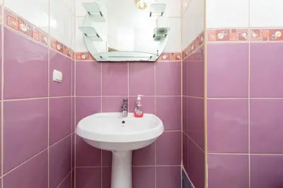 a purple tiled bathroom with a sink and a mirror at Leyla palas in Istanbul