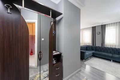 a living room with a couch and a glass door at Leyla palas in Istanbul