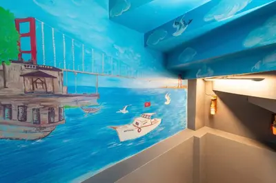 a mural of the golden gate bridge and a boat at Leyla palas in Istanbul