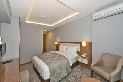 a hotel room with a bed and a chair at Floransa City Hotel in Istanbul
