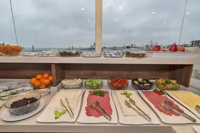 a buffet with many plates of food on a table at Marcello Hotel in Istanbul