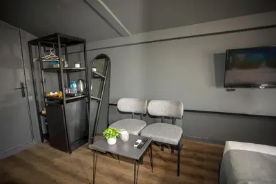 a living room with two chairs and a table and a tv at Arkem Deluxe in Istanbul