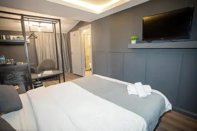 a hotel room with a bed and a flat screen tv at Arkem Deluxe in Istanbul