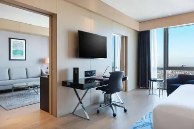 a hotel room with a desk and a tv at Wyndham Grand Istanbul Levent Hotel & Conference Center in Istanbul