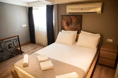 a bedroom with a large bed with two towels on it at The Hera Hotels in Istanbul