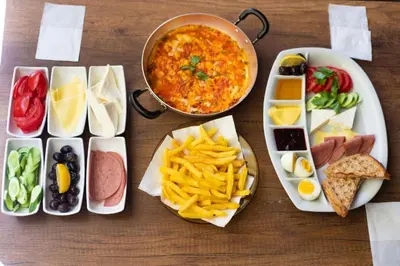 a table with plates of food and a bowl of food at The Hera Hotels in Istanbul