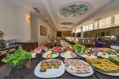 a table with many plates of food on it at Green Anka Hotel in Istanbul
