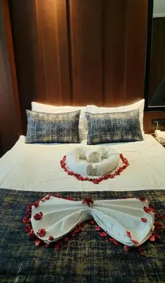 a bed with a white dress with a heart on it at Green Anka Hotel in Istanbul