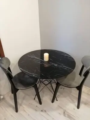 a black table and two chairs with a candle on it at Central of İstanbul near to so many historic place in Istanbul