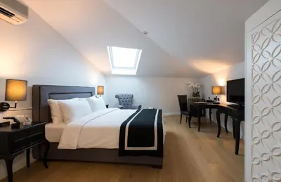 a bedroom with a bed and a desk and a computer at Régie Ottoman Istanbul - Special Category in Istanbul