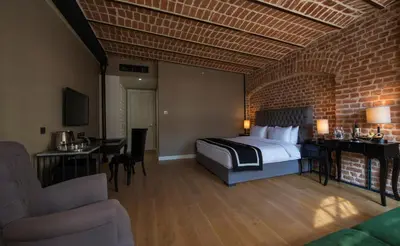 a hotel room with a bed and a brick wall at Régie Ottoman Istanbul - Special Category in Istanbul