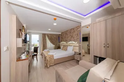 a hotel room with a bed and a couch at Raimond Hotel in Istanbul