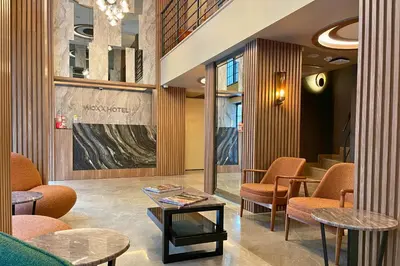 a lobby with chairs and a table in a building at Woxx Hotel in Istanbul