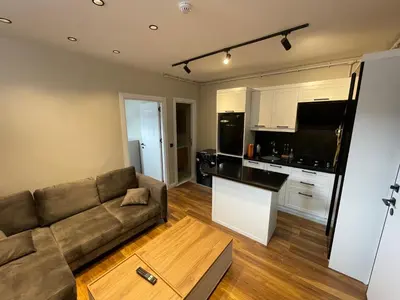 a living room with a couch and a kitchen at ARC HOUSE in Istanbul