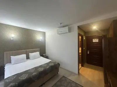 a hotel room with a bed and a hallway at Atlantik Butik Hotel in Tekirdag