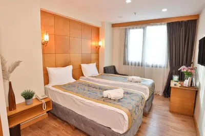 a hotel room with a bed with two pigs on it at Cumbali Plaza Hotel in Istanbul