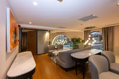 a living room with a couch and tables and chairs at Baver Hotel in Istanbul