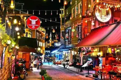 a city street at night with people walking down the street at Historical comfy flat in Beyoğlu tophane, galata in Istanbul