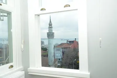 a window with a view of a clock tower at CK SULTANAHMET HOTEL in Istanbul