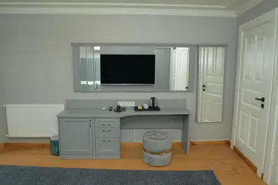 a bathroom with a desk with a tv on the wall at CK SULTANAHMET HOTEL in Istanbul