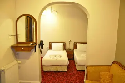 a hotel room with two beds and a mirror at No20 Hotel Sultanahmet in Istanbul