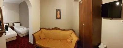 a room with a chair and a bed and a television at No20 Hotel Sultanahmet in Istanbul