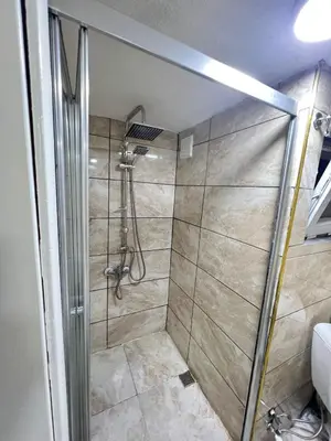 a shower with a glass door in a bathroom at Taksim Milenyum Suites in Istanbul