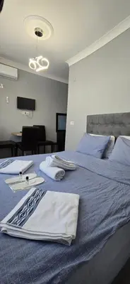 a large blue bed with towels on top of it at Taksim Milenyum Suites in Istanbul