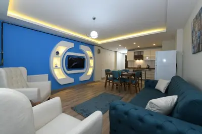 a living room with a couch and a large screen at Uzay Suite 1 in Istanbul
