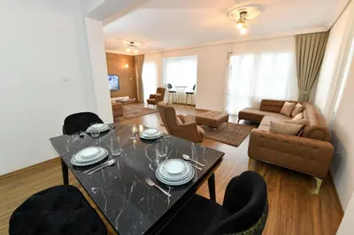 a living room with a dining table and a couch at Dilek Apartments in Istanbul