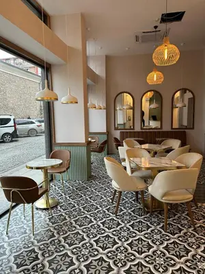 a restaurant with tables and chairs and mirrors at Iris Han Hotel in Istanbul