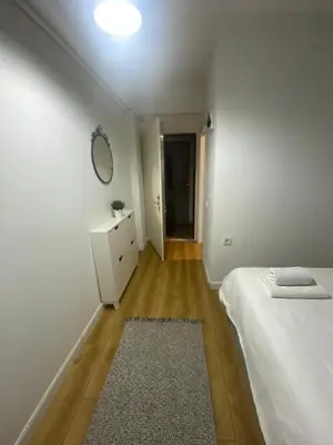 a white bedroom with a bed and a mirror at BEYOĞLU in Istanbul