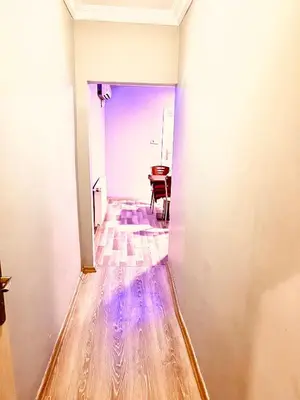 a hallway with a wooden floor and a table at otel grand sami in Istanbul