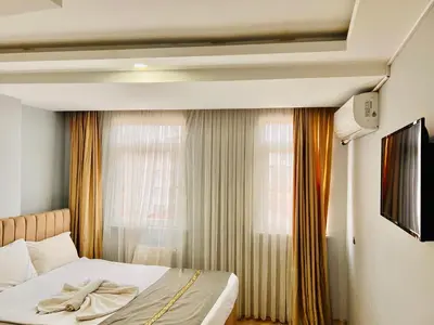a bedroom with a bed and a window at otel grand sami in Istanbul