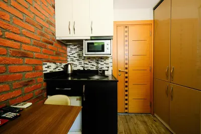 a small kitchen with a brick wall at Taksim Celebi Suites in Istanbul