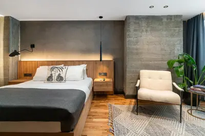 a bedroom with a bed and a chair at Urban Quarters - Gülhane in Istanbul