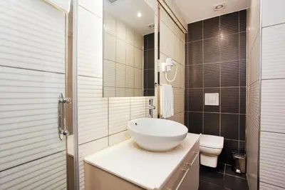 a bathroom with a white sink and a toilet at Miller Hotel in Istanbul