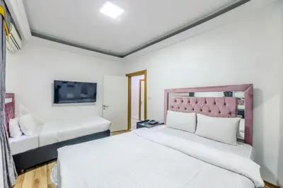 a bedroom with a large bed and a tv at Sisli Form Hotel in Istanbul