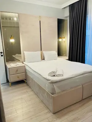a bedroom with a large bed and a mirror at Cantrmen Suites in Istanbul
