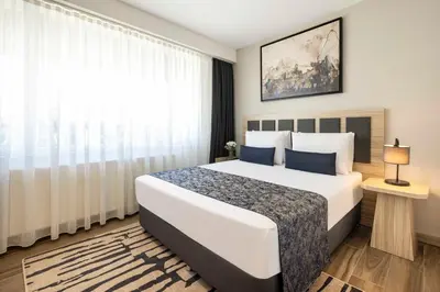 a bedroom with a large bed and a window at The Capri Hotel Osmanbey in Istanbul