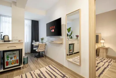 a living room with a mirror and a table at The Capri Hotel Osmanbey in Istanbul