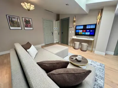 a living room with a couch and a tv at Weingart Suites Hotel in Istanbul